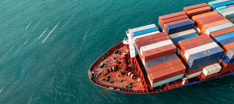 Cargo ship with shipping containers filled with machine tools